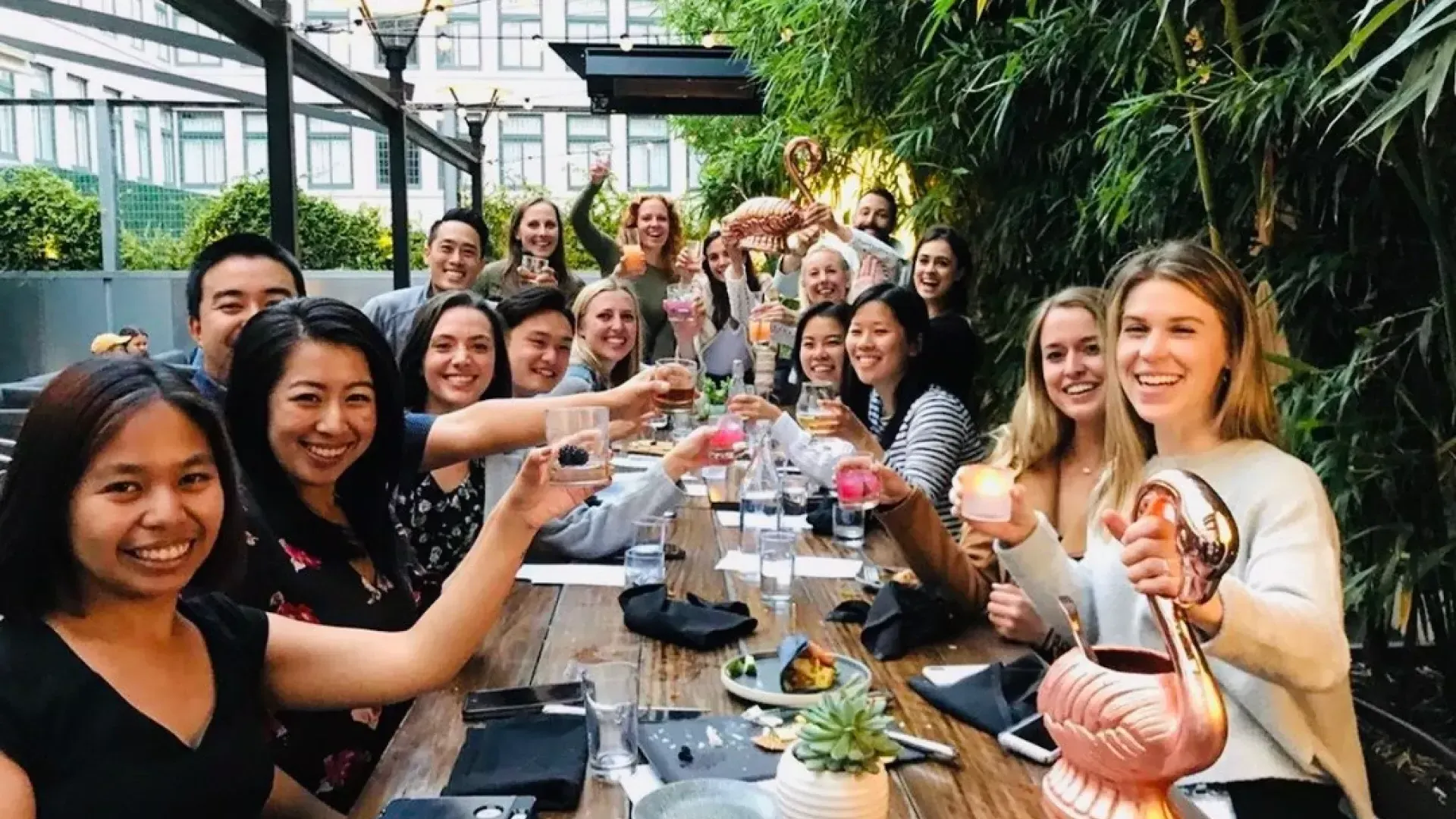 A group of people toasting at Dirty Habit